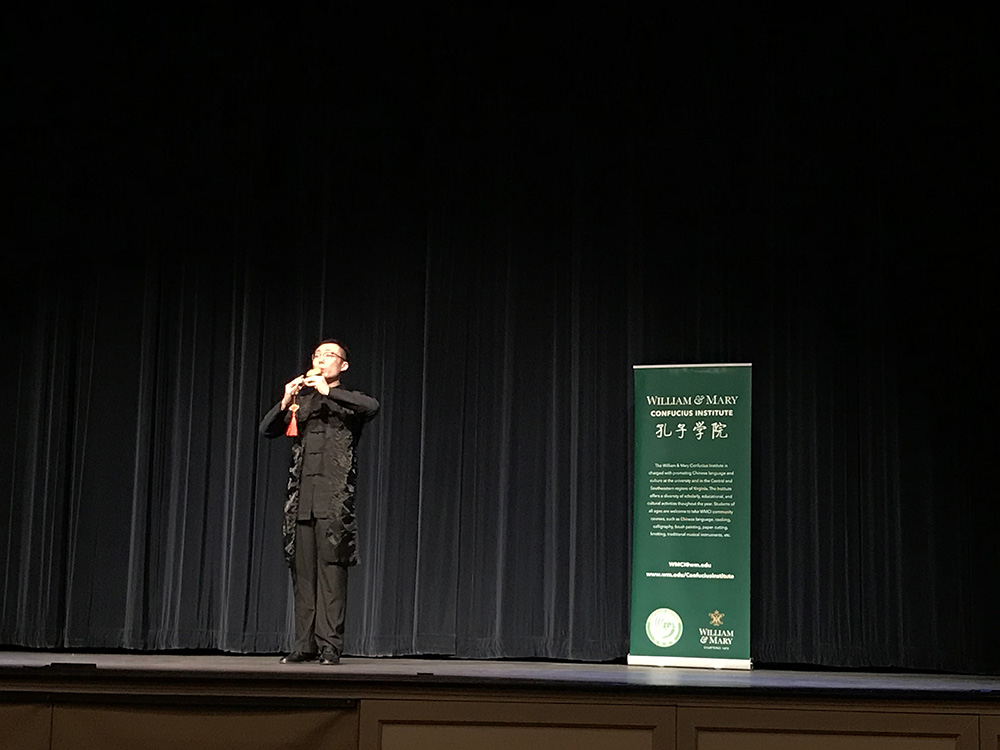 2. Volunteer Teacher Jie Hou performs a piece on the hulusi 2. Volunteer Teacher Jie Hou performs a piece on the hulusi