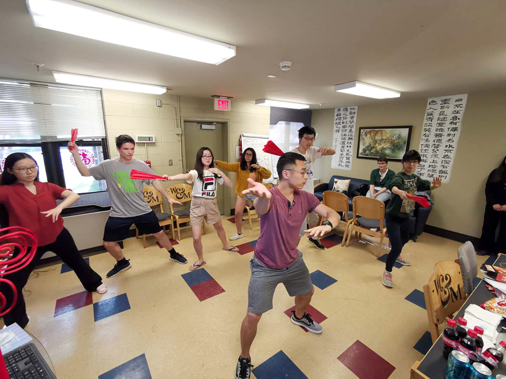 1. Student Intern Xiusen Pan teaches participants Taiji Fan forms